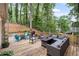 Inviting back deck with outdoor seating and a lush, wooded backdrop at 1945 Wenlok Ne Trl, Marietta, GA 30066