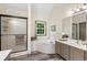 Bright bathroom featuring a tub, glass shower stall, double vanity, and wood-look flooring at 1945 Wenlok Ne Trl, Marietta, GA 30066