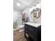 Bathroom featuring modern vanity with gold fixtures and shower with decorative curtain at 1945 Wenlok Ne Trl, Marietta, GA 30066