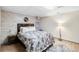 Comfortable bedroom with a stylish accent wall and a striking animal print rug on hardwood floor at 1945 Wenlok Ne Trl, Marietta, GA 30066