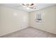 Bright bedroom with neutral carpet, ceiling fan and window bringing in natural light at 1945 Wenlok Ne Trl, Marietta, GA 30066