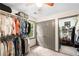 Walk-in closet with plenty of room for hanging clothes and accessories, with a window for natural light at 1945 Wenlok Ne Trl, Marietta, GA 30066