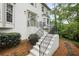 Close up of home's front entrance with bay window, painted stairs and iron handrail at 1945 Wenlok Ne Trl, Marietta, GA 30066