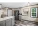 Bright kitchen featuring stainless steel appliances, gray cabinets, and a breakfast bar at 1945 Wenlok Ne Trl, Marietta, GA 30066