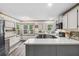 Well-lit kitchen with modern appliances, gray cabinets, and a peninsula countertop at 1945 Wenlok Ne Trl, Marietta, GA 30066