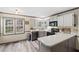 Well-lit kitchen with modern appliances, gray cabinets, and a peninsula countertop at 1945 Wenlok Ne Trl, Marietta, GA 30066