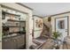 Living room area with wet bar, stairs, and an exterior entrance door at 1945 Wenlok Ne Trl, Marietta, GA 30066