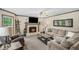 Cozy living room featuring a fireplace, plush furniture, and abundant natural light at 1945 Wenlok Ne Trl, Marietta, GA 30066