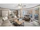 Bright living room with a comfortable sectional sofa, ceiling fan, and sliding glass doors to the patio at 1945 Wenlok Ne Trl, Marietta, GA 30066