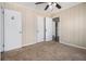 Bedroom with neutral carpet, paneled walls, closet and doorway to another room at 2564 Brentwood Rd, Decatur, GA 30032