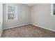 Bedroom featuring neutral carpeting, off white walls, and windows with outside views at 2564 Brentwood Rd, Decatur, GA 30032