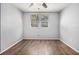 Cozy bedroom with wood-look flooring, neutral walls, a ceiling fan, and a window for natural light at 2564 Brentwood Rd, Decatur, GA 30032
