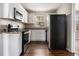 Well-lit kitchen featuring stainless steel appliances, granite countertops, and white cabinetry at 2564 Brentwood Rd, Decatur, GA 30032