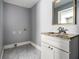 Laundry area with tile floors, white vanity with granite countertop, and connections for washer and dryer at 2564 Brentwood Rd, Decatur, GA 30032