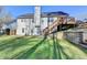 The backyard featuring tiered retaining walls, lush lawn, and outdoor entertaining space with access to the house at 4960 Markim Forest Ln, Sugar Hill, GA 30518