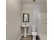 Bathroom featuring modern fixtures, pedestal sink, toilet, and shower with white tile at 4960 Markim Forest Ln, Sugar Hill, GA 30518