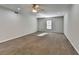 Spacious bedroom with neutral walls, carpet, ceiling fan and a window offering natural light at 4960 Markim Forest Ln, Sugar Hill, GA 30518