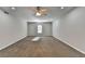 Spacious bedroom with neutral walls, carpet, ceiling fan and a window offering natural light at 4960 Markim Forest Ln, Sugar Hill, GA 30518