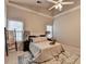 Cozy bedroom with vaulted ceilings, ceiling fan, neutral carpet, and a beautiful decorative ladder at 4960 Markim Forest Ln, Sugar Hill, GA 30518