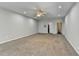Spacious bedroom with neutral walls, carpet, ceiling fan and access to bathroom and closet at 4960 Markim Forest Ln, Sugar Hill, GA 30518