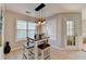 Bright dining area featuring stylish lighting, a table with benches, and a view to the exterior at 4960 Markim Forest Ln, Sugar Hill, GA 30518