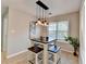 Dining nook illuminated by decorative pendant lighting and surrounded by windows at 4960 Markim Forest Ln, Sugar Hill, GA 30518