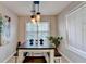 Well-lit dining area with a table, stools, a window, and modern pendant lighting at 4960 Markim Forest Ln, Sugar Hill, GA 30518