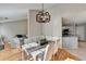 Dining space showcases modern lighting and transitions into the living room and kitchen at 4960 Markim Forest Ln, Sugar Hill, GA 30518