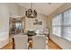 Inviting dining area featuring decorative lighting and a horse painting at 4960 Markim Forest Ln, Sugar Hill, GA 30518