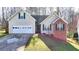 Charming single-Gathering home with a two-car garage, front lawn, and well-maintained landscaping at 4960 Markim Forest Ln, Sugar Hill, GA 30518