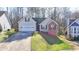 Charming single-Gathering home with a two-car garage, front lawn, and well-maintained landscaping at 4960 Markim Forest Ln, Sugar Hill, GA 30518