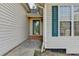 Welcoming front entrance features neutral siding, green shutters, and a well-lit doorway at 4960 Markim Forest Ln, Sugar Hill, GA 30518