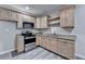 Modern kitchen with stainless steel appliances, light wood cabinets and countertops at 4960 Markim Forest Ln, Sugar Hill, GA 30518