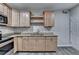 Modern kitchen featuring stainless steel appliances, light wood cabinets, and stone countertops at 4960 Markim Forest Ln, Sugar Hill, GA 30518