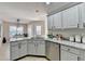Kitchen with granite countertops and stainless steel appliances and view to breakfast nook at 4960 Markim Forest Ln, Sugar Hill, GA 30518