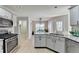 Kitchen with granite countertops, stainless steel oven and cooktop and painted cabinets at 4960 Markim Forest Ln, Sugar Hill, GA 30518