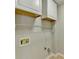Neutral laundry room with white painted cabinets and wire shelving at 4960 Markim Forest Ln, Sugar Hill, GA 30518