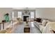 Bright living room with fireplace, neutral decor, and hardwood floors at 4960 Markim Forest Ln, Sugar Hill, GA 30518