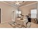 Spacious main bedroom featuring a tray ceiling, an area rug, and neutral decor at 4960 Markim Forest Ln, Sugar Hill, GA 30518