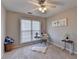 Bright home office with a modern desk, plush rug, and natural light, creating an inspiring workspace at 4960 Markim Forest Ln, Sugar Hill, GA 30518