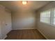 This is a bright bedroom with wood flooring, a closet, and a window providing natural light at 2703 Rainbow Forest Dr, Decatur, GA 30034