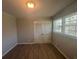 Clean bedroom with natural light from two windows, and closet with modern doors at 2703 Rainbow Forest Dr, Decatur, GA 30034