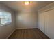 Bright bedroom features modern vinyl floors, a window letting in natural light, and a closet for convenient storage at 2703 Rainbow Forest Dr, Decatur, GA 30034