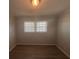 This bedroom offers great natural light through a window and modern wood-look flooring at 2703 Rainbow Forest Dr, Decatur, GA 30034