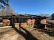 Rear exterior elevation of brick home with covered patio at 2703 Rainbow Forest Dr, Decatur, GA 30034