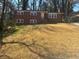 Beautiful two-story brick home with a spacious front yard and mature trees at 2703 Rainbow Forest Dr, Decatur, GA 30034