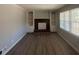 Cozy living room features a brick fireplace, built-in shelving, and new flooring at 2703 Rainbow Forest Dr, Decatur, GA 30034