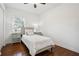 Well-lit bedroom with hardwood floors, neutral decor, and an open closet door at 3970 Scott Dr, Forest Park, GA 30297