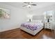 Bright bedroom with hardwood floors, complemented by matching nightstands and a ceiling fan at 3970 Scott Dr, Forest Park, GA 30297