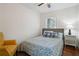 Cozy bedroom features hardwood flooring, a ceiling fan, and a yellow armchair at 3970 Scott Dr, Forest Park, GA 30297